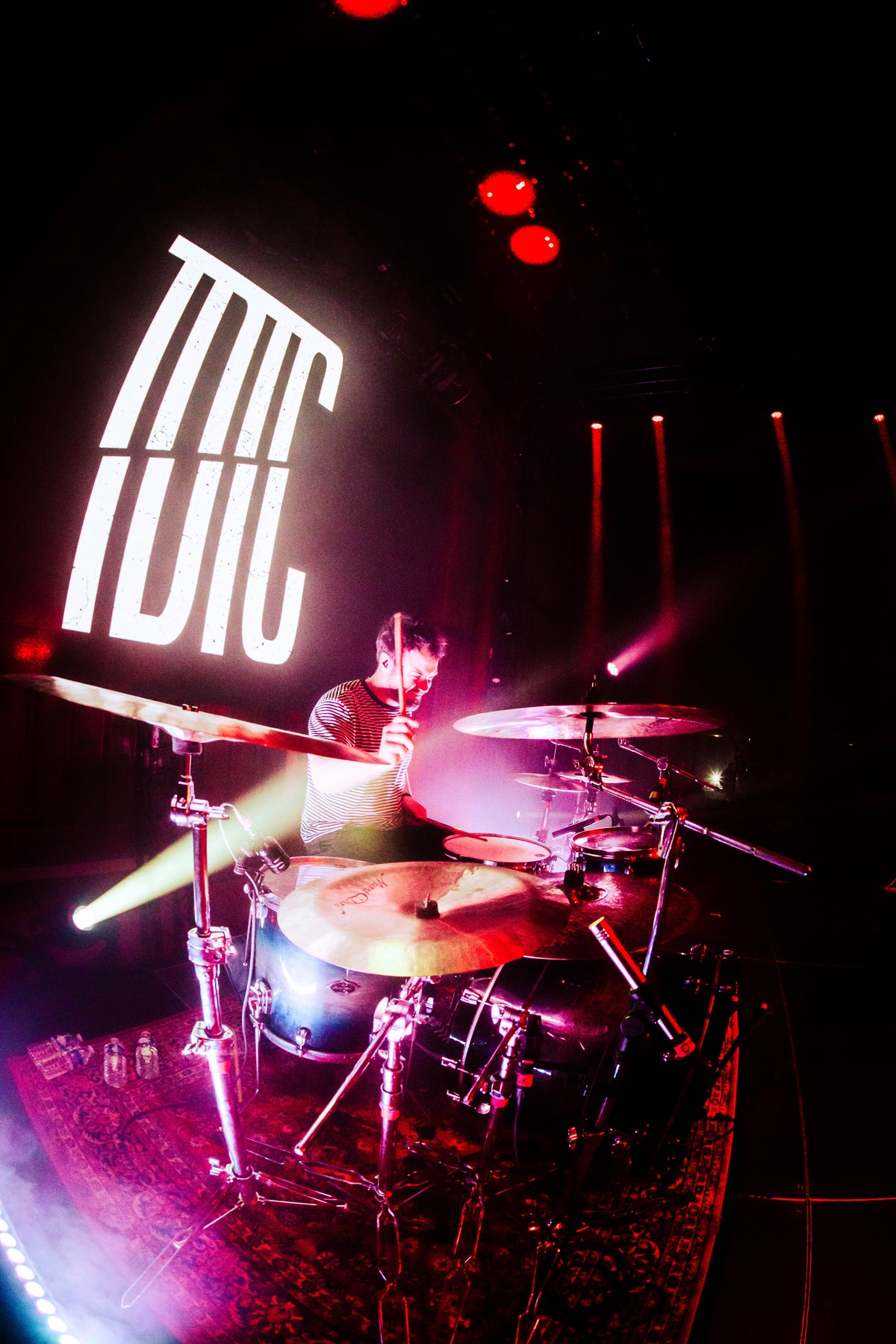 DALI drummer performing under pink stage lights